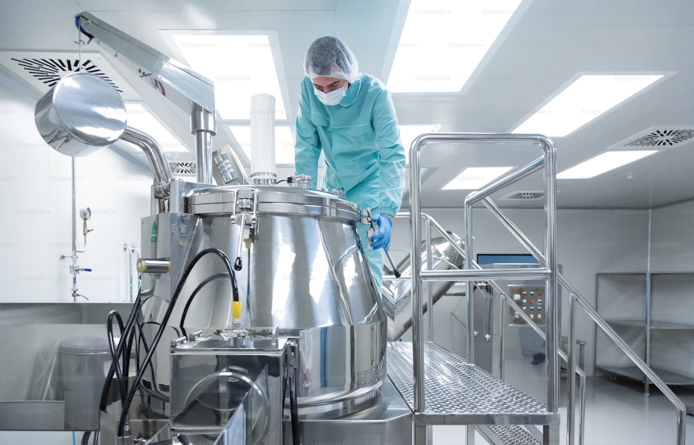 Pharmaceutical technician in sterile environment at pharmacy industry