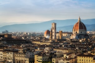 Florence Cathedral (Cattedrale di Santa Maria del Fiore) in historic center of Florence, Italy with panoramic view of the city. Florence Cathedral is the major tourist attraction of Tuscany, Italy.