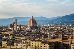 Florence Cathedral (Cattedrale di Santa Maria del Fiore) in historic center of Florence, Italy with panoramic view of the city. Florence Cathedral is the major tourist attraction of Tuscany, Italy.