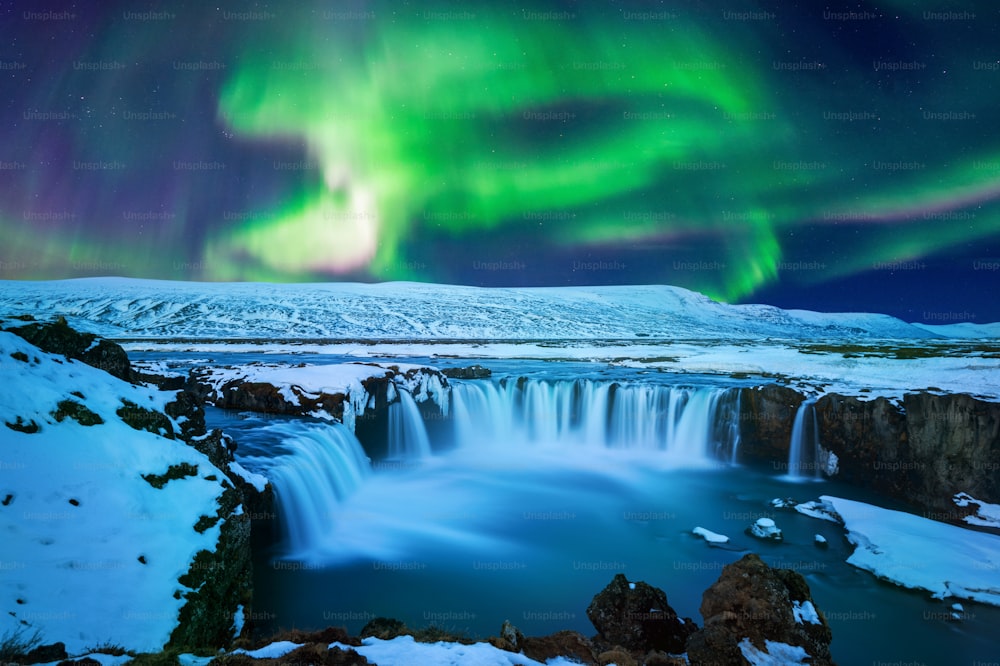 aurora boreale, aurora boreale alla cascata di Godafoss in inverno, Islanda.