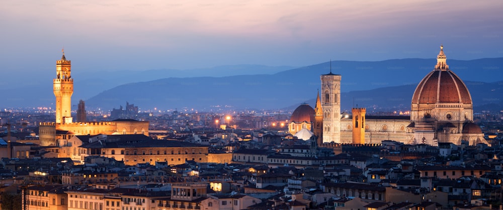 Florence Cathedral (Cattedrale di Santa Maria del Fiore) in historic center of Florence, Italy with night panoramic view of the city. Florence Cathedral is major tourist attraction of Tuscany, Italy.