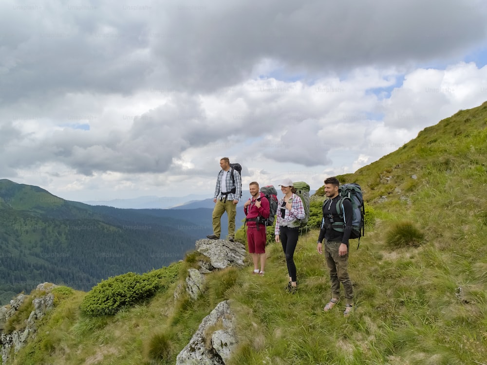 The four people standing on the picturesque mountain