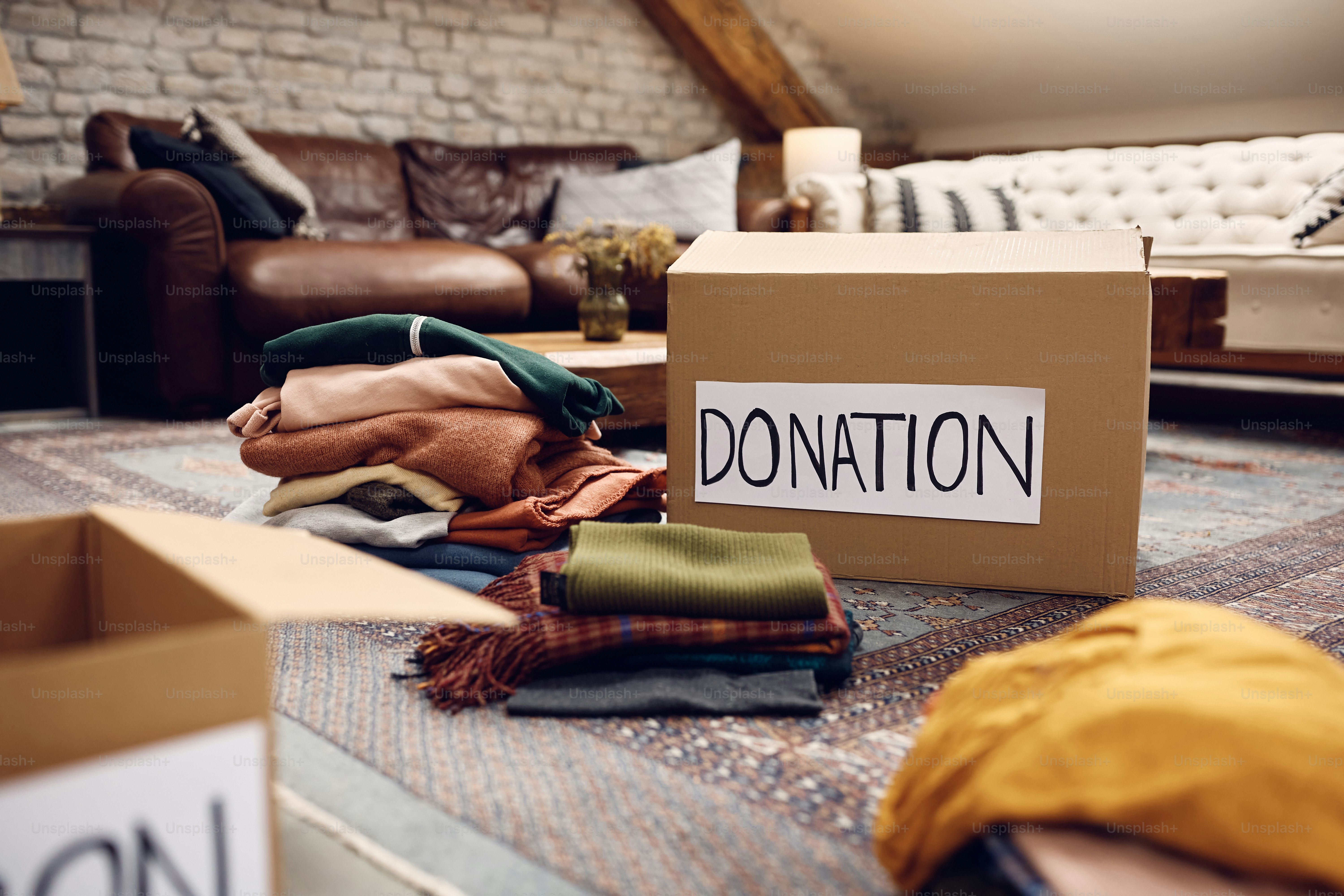 Cardboard boxes with clothes for donation.