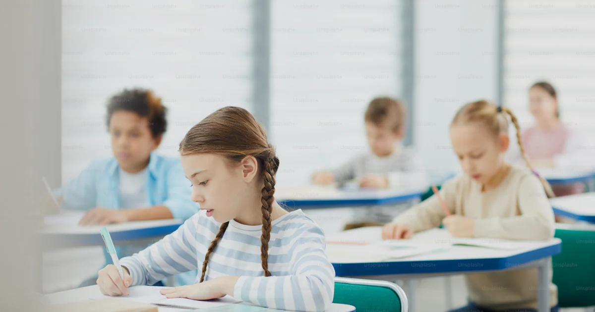 Doing Lesson Horizontal Caucasian girl focused shot of primary school students doing ...