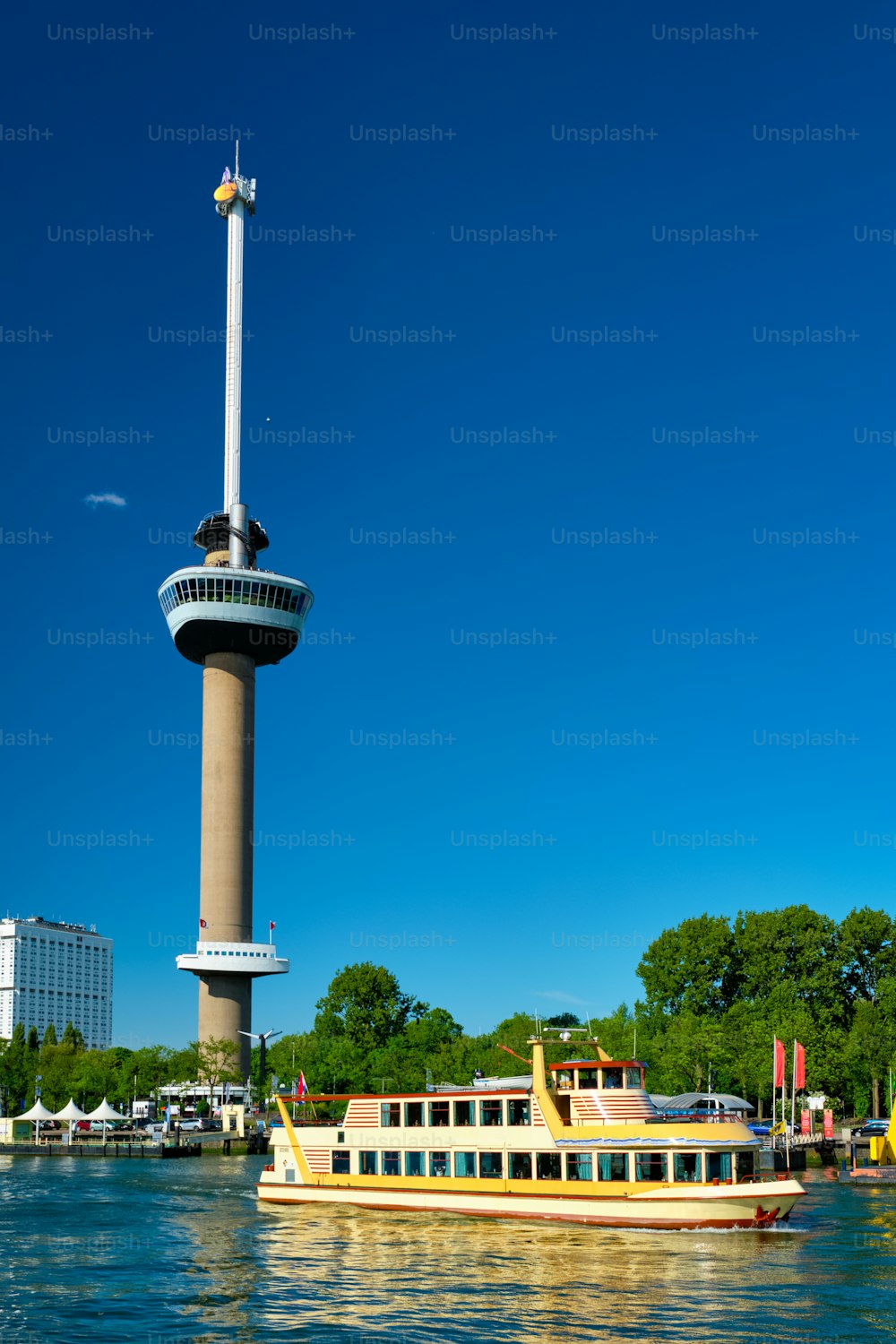 Rotterdam cityscape with Euromast observation tower and tourist boat on Nieuwe Maas river. Rotterdam, Netherlands