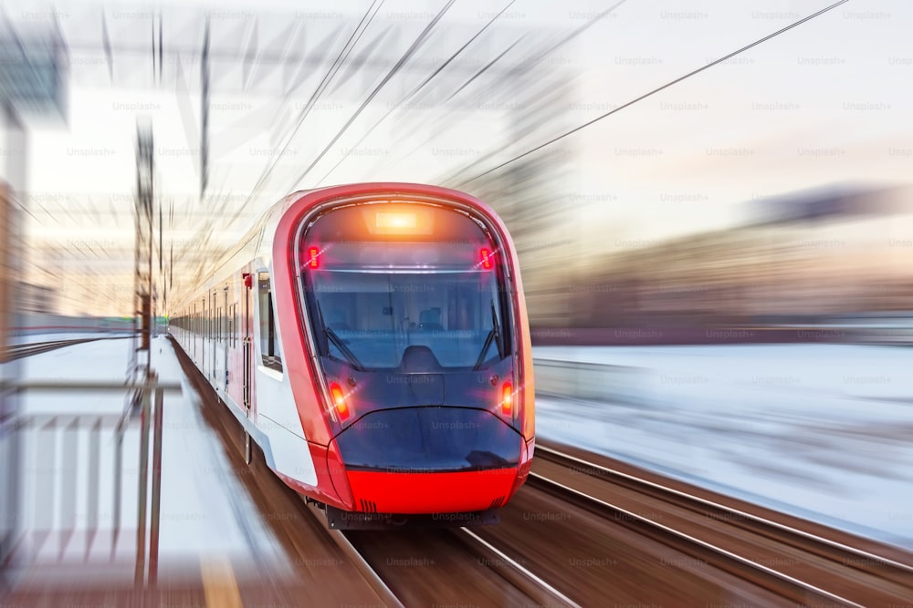 High speed modern commuter train red lights, motion blur