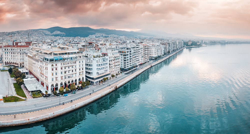 Aerial panorama over the promenade of Thessaloniki city with facades of buildings and a walking pedestrian path along the sea. Visit Greece and sightseeing concept