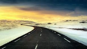 A long straight road at sunset in winter.