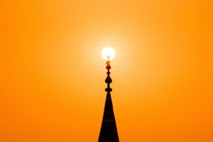 Red sunset with sun and silhouette of mosque minaret