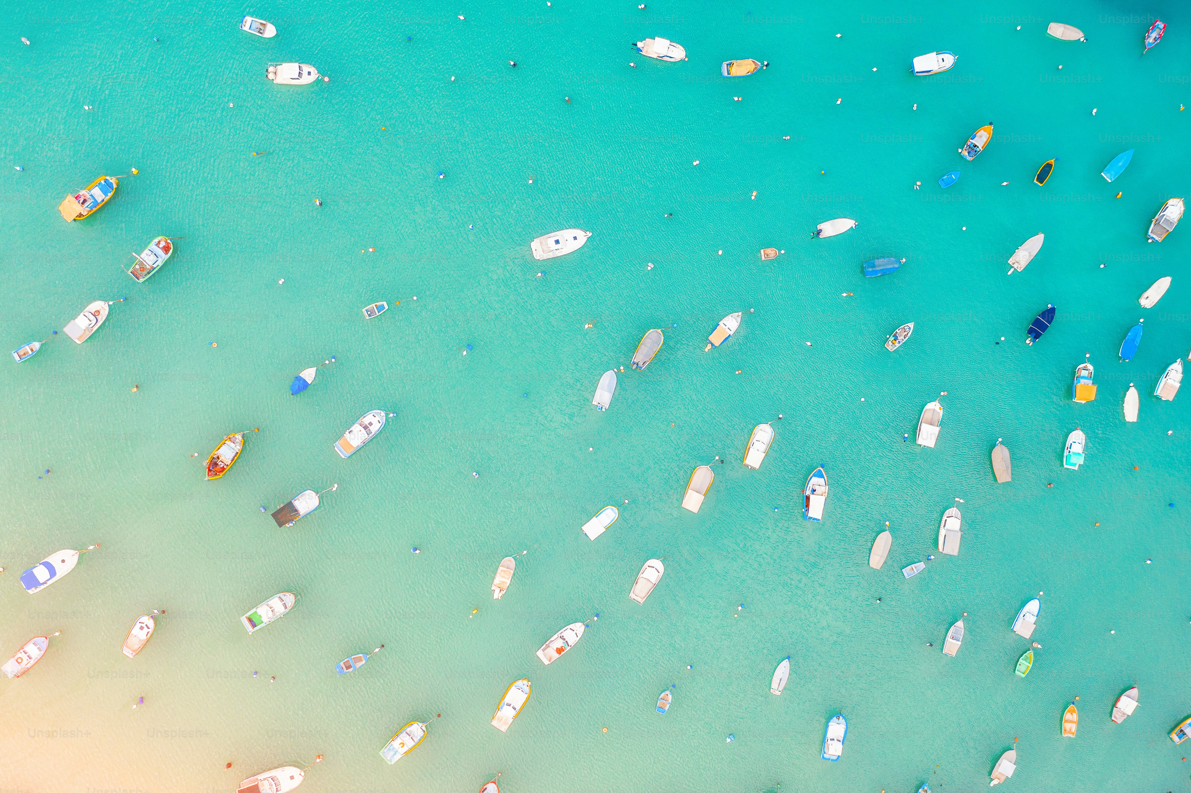 Boats in the harbor of Mediterranean fishing village, aerial view