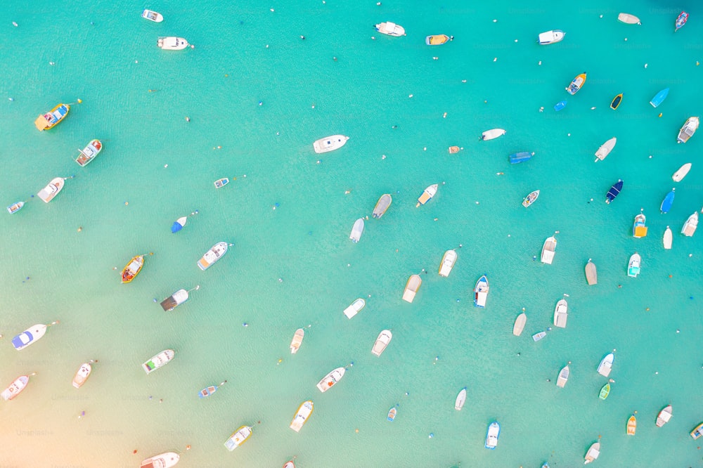 Boats in the harbor of Mediterranean fishing village, aerial view