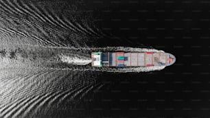 Aerial top view container ship on deep sea for logistics, import export, shipping or transportation to worldwide.