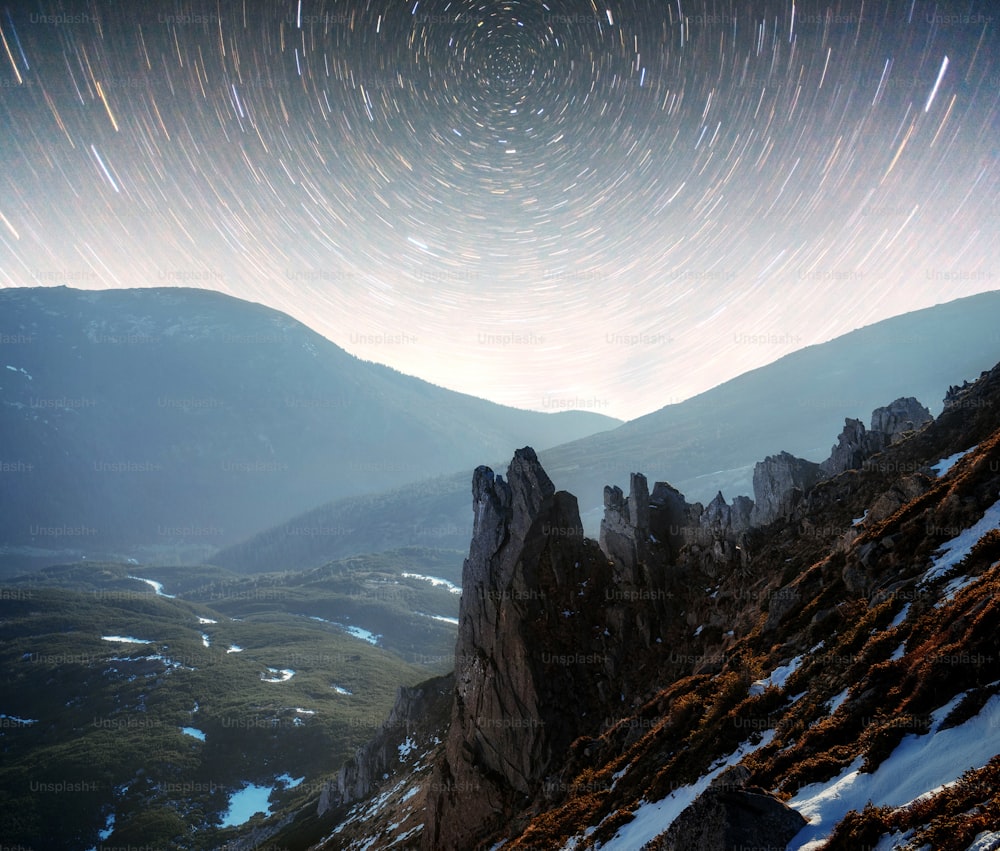 Landscape with milky way, Night sky with stars on the mountain, Long exposure photograph, with grain.