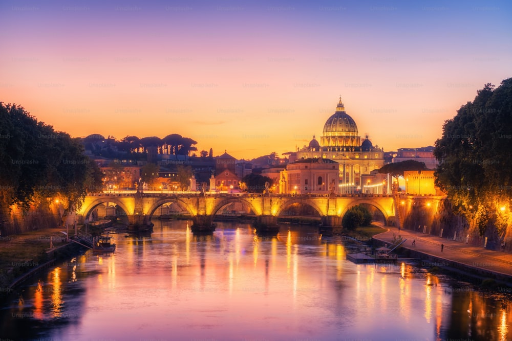 Rome Skyline with Vatican St Peter Basilica and St Angelo Bridge crossing Tiber River in city center of Rome Italy , historical landmarks attraction of the Ancient Rome , travel destination of Italy.