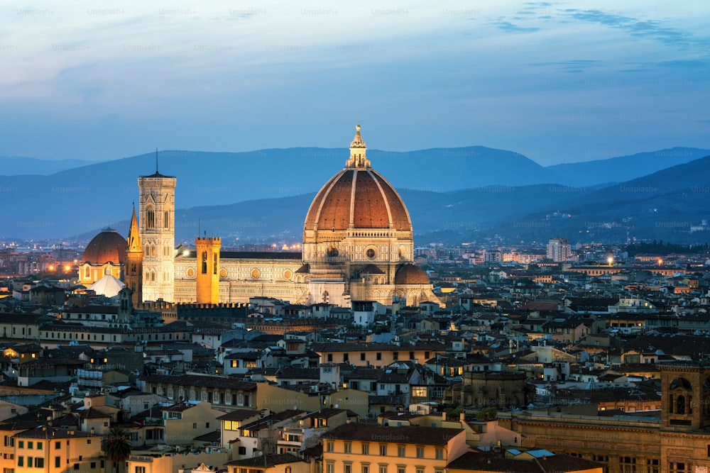 Florence Cathedral (Cattedrale di Santa Maria del Fiore) in historic center of Florence, Italy with night panoramic view of the city. Florence Cathedral is major tourist attraction of Tuscany, Italy.