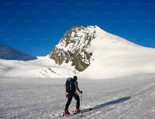 A male backcountry skier on his way to the Rimpfischhorn peak in the Alps of Switzerland near Zermatt