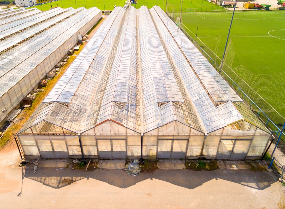 Greenhouse for flowers, vegetables and marijuana growing. Modern agriculture from above. Camera flight over garden.