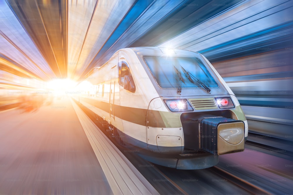 Railroad travel passenger train with motion blur effect, industrial a district of the city.