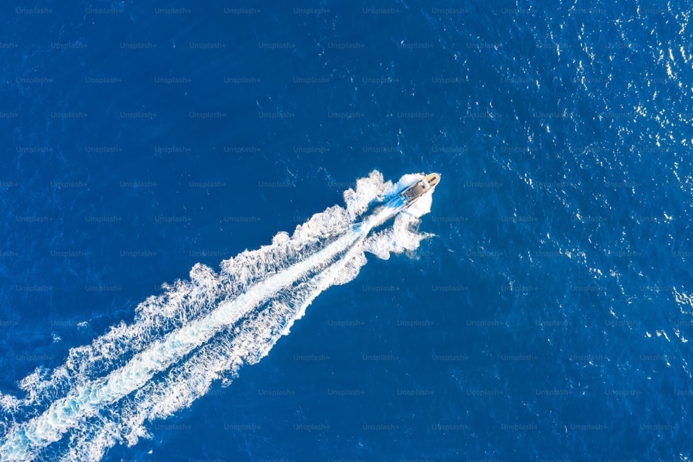 Boat launch at high speed floats in the Mediterranean, aerial top view