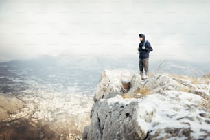 Hiker man standing at mountain viewpoint, travel lifestyle hiking wanderlust concept