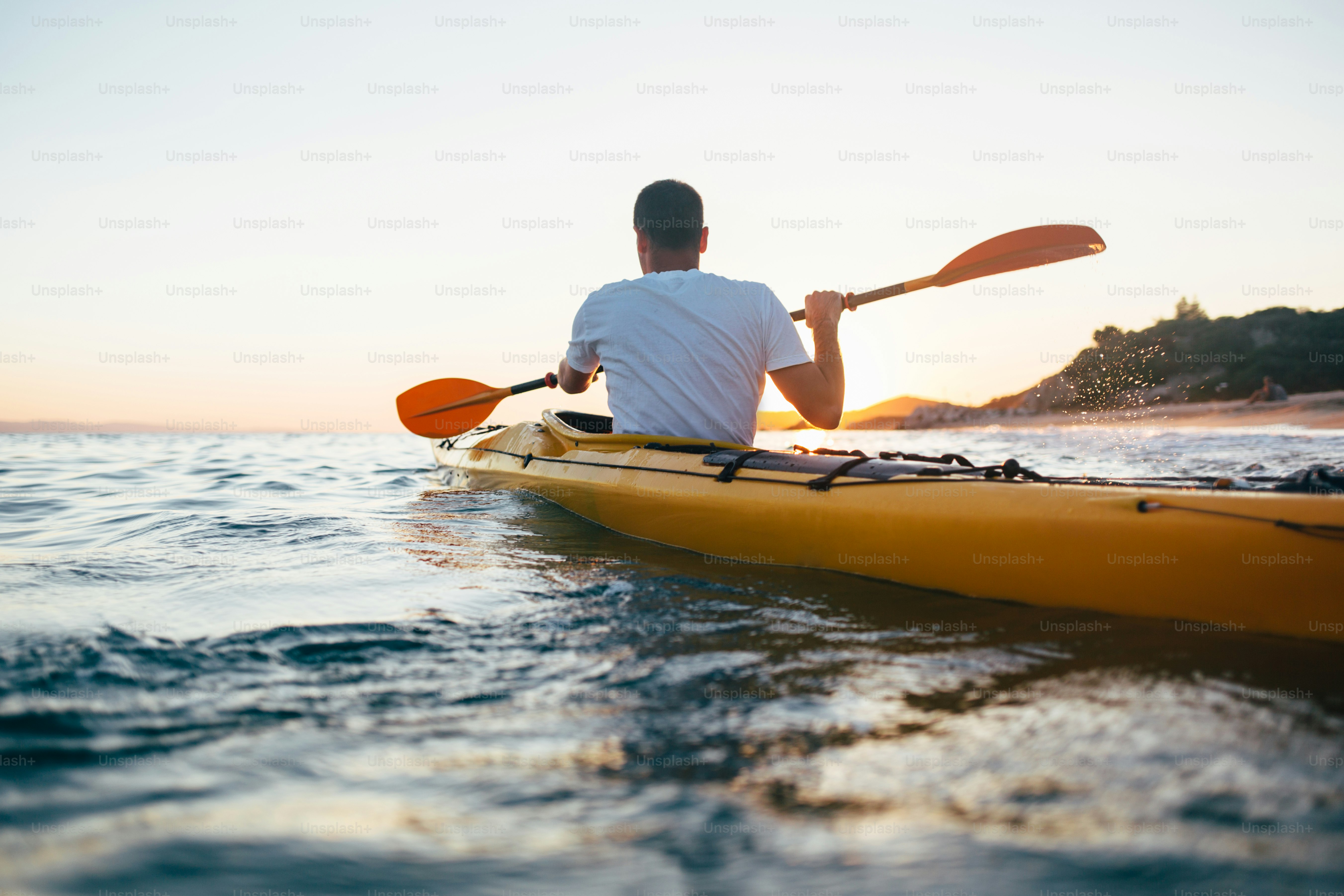 Man kayaker paddling the kayak at sunset sea. photo – Sunset Image on ...
