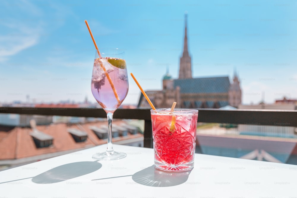 Two glasses of cocktails on a table in bar terrace with observation deck