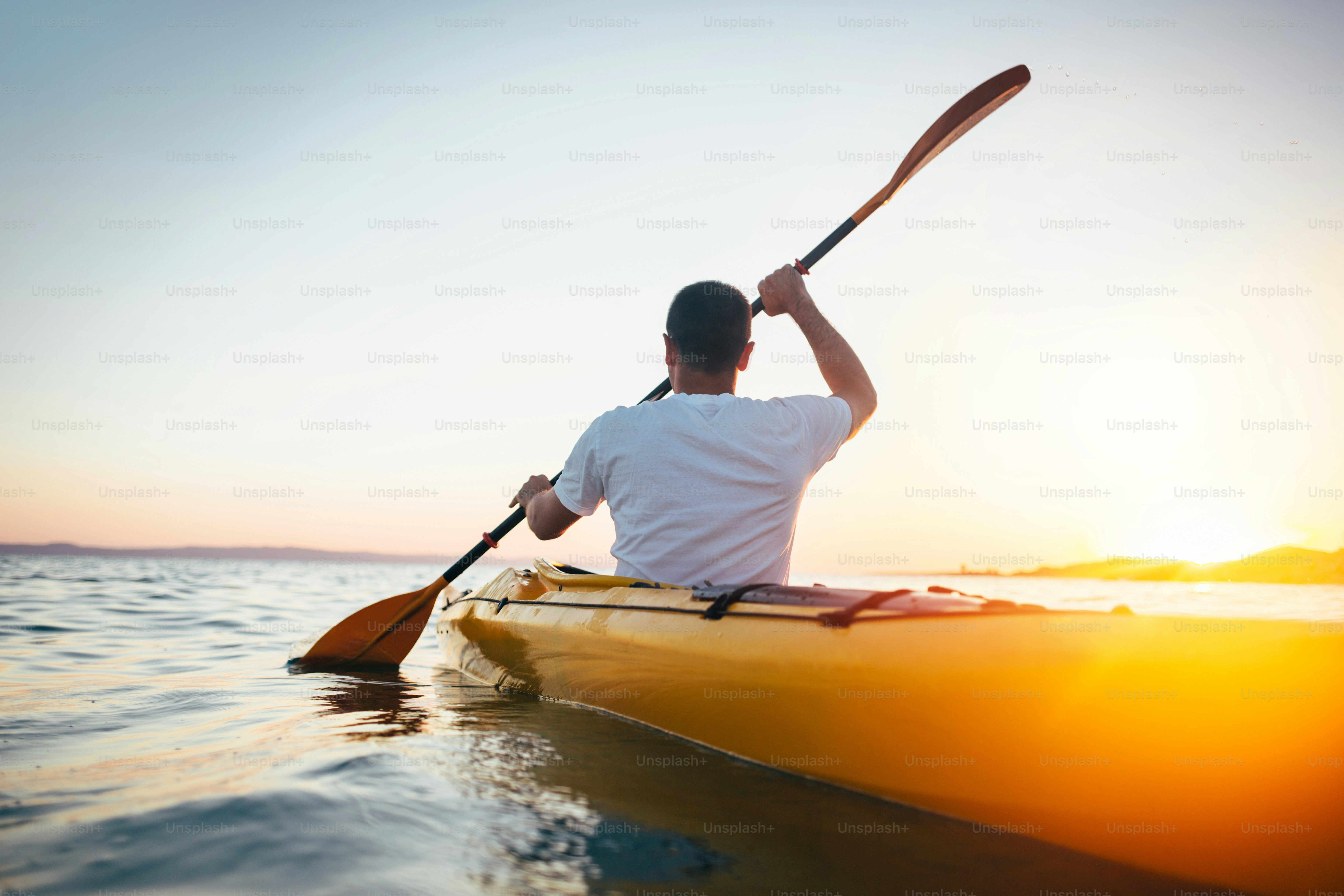 Man kayaker paddling the kayak at sunset sea. photo – Travel Image on ...