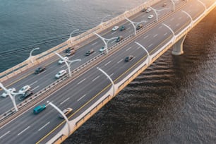 Aerial view on traffic bridge over bay gulf, cars on bridge