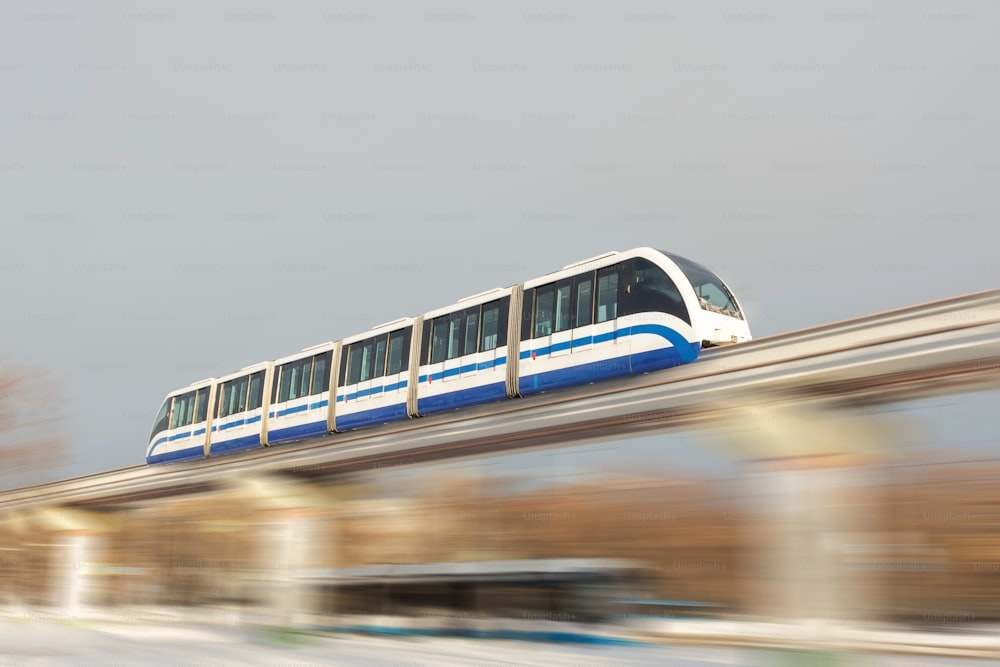 High speed subway train on the air bridge travels at high speed over city streets