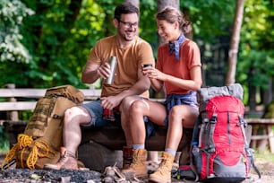 Young couple camping in forest together. Sport, nature, love and vacation concept.