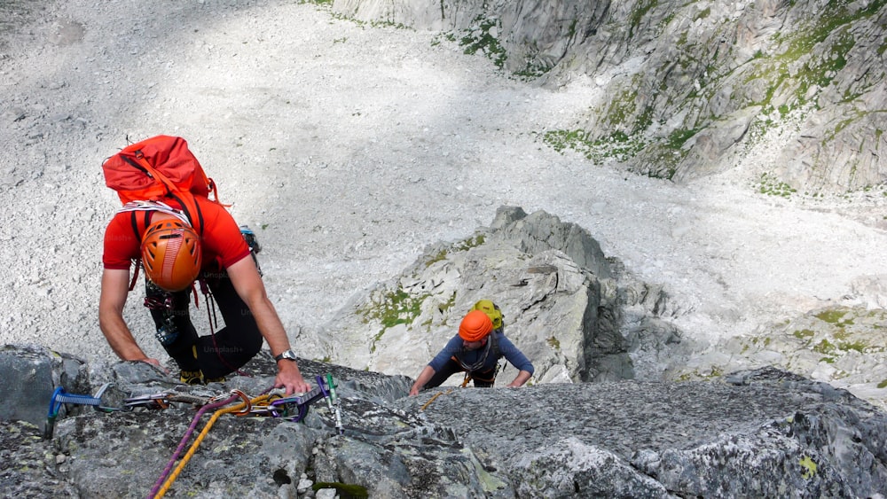 two male rock climbers on a granite climbing route in the high alpine peaks of southeastern Switzerland in the well-known Val Bregaglia