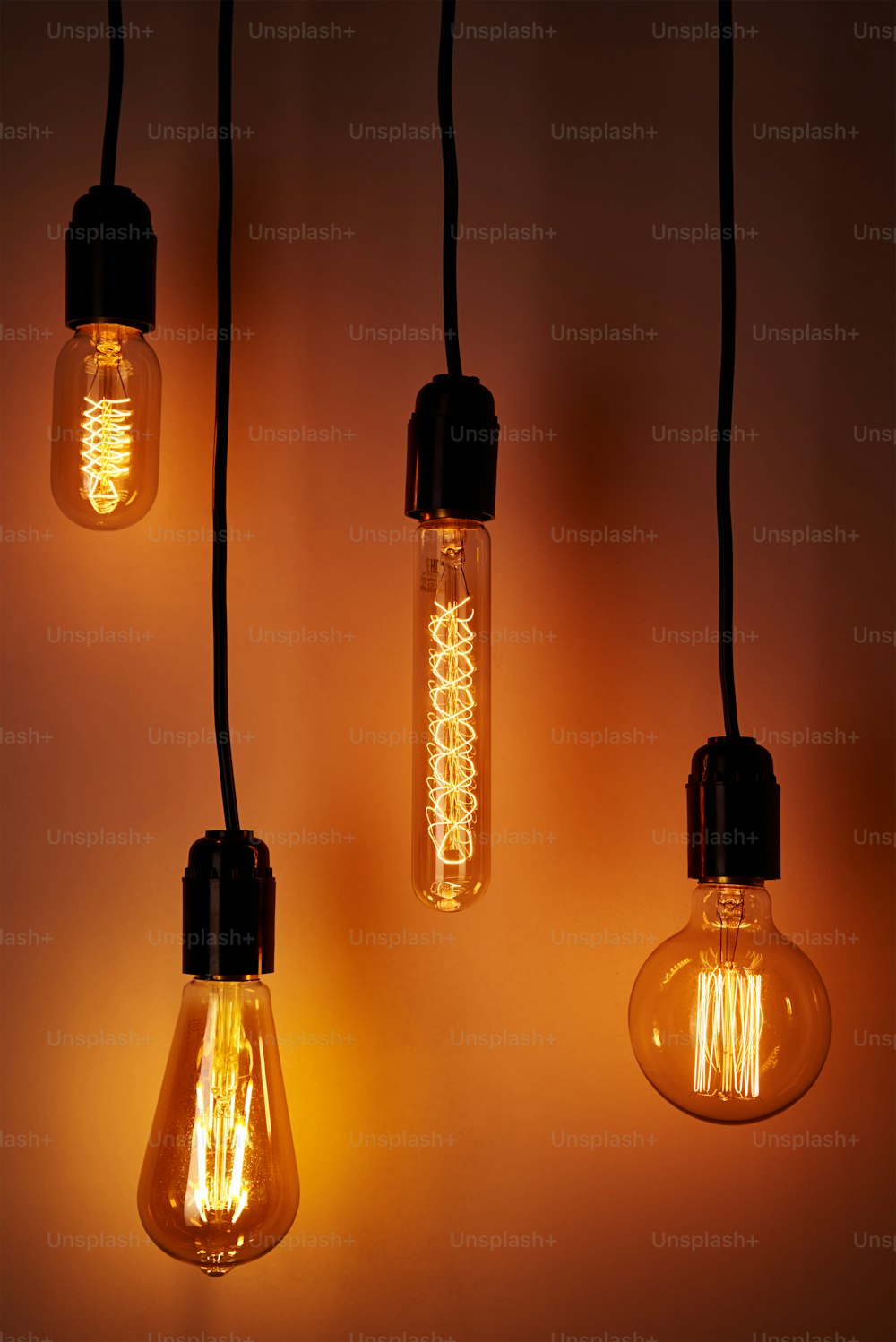 Set of vintage light bulb on orange background. Glowing edison bulb