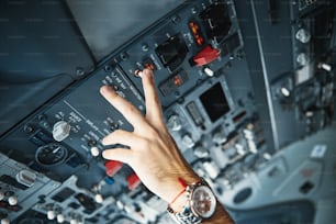 Close up photo of a hand of a pilot touching the switcher in a flight deck and controlling the yaw damper