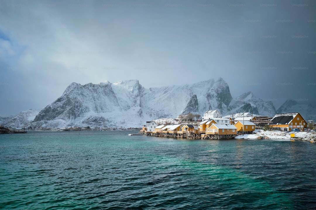 Yellow rorbu houses of Sakrisoy fishing village with snow in winter. Lofoten islands, Norway