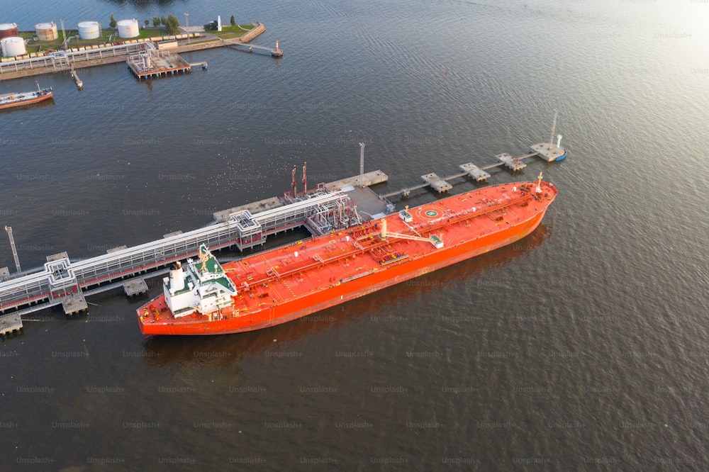 Oil tanker in industrial port at unloading of bulk contents, aerial view