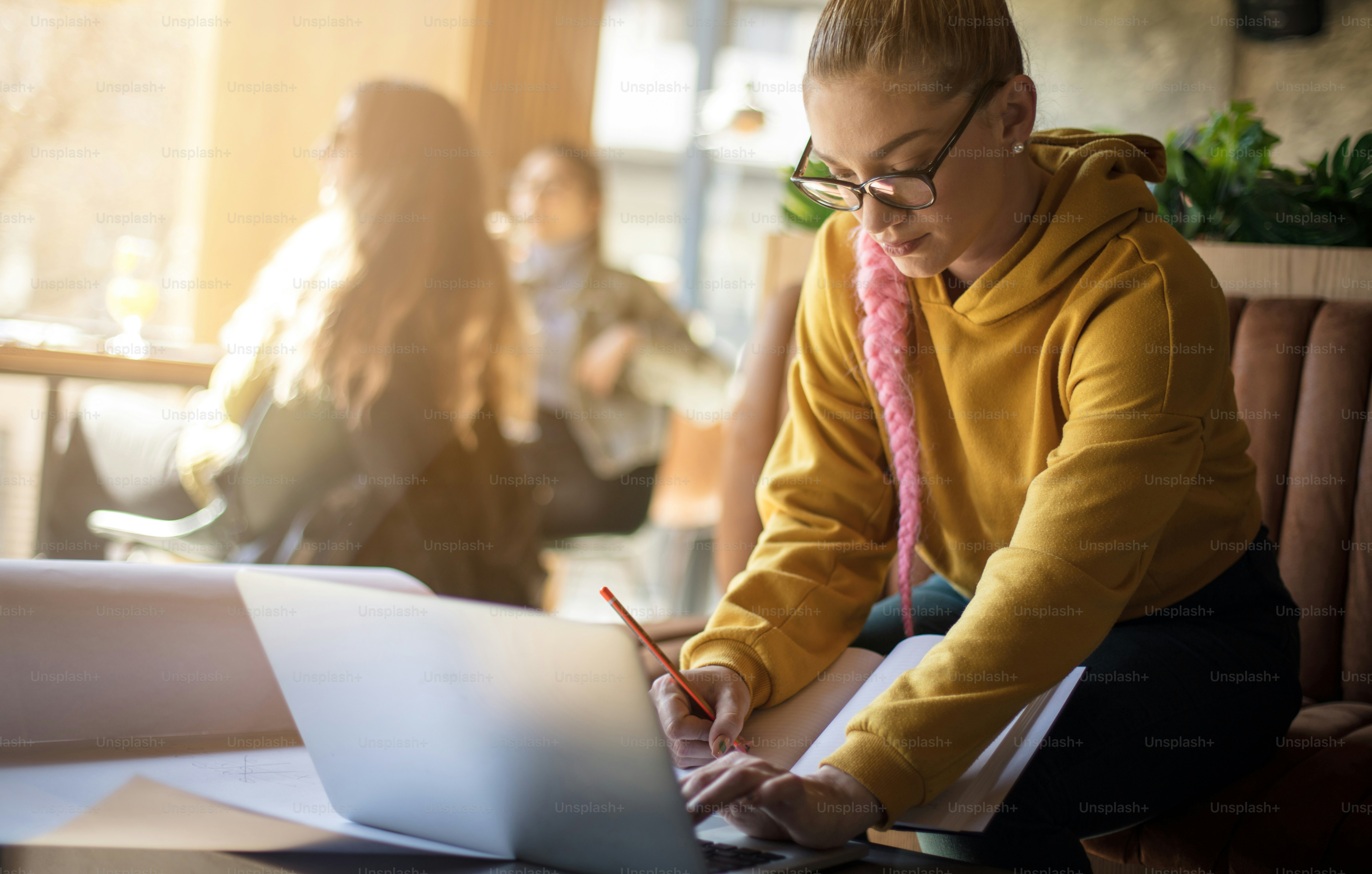 She only strives for success through hard work. Young student girl working in cafe.