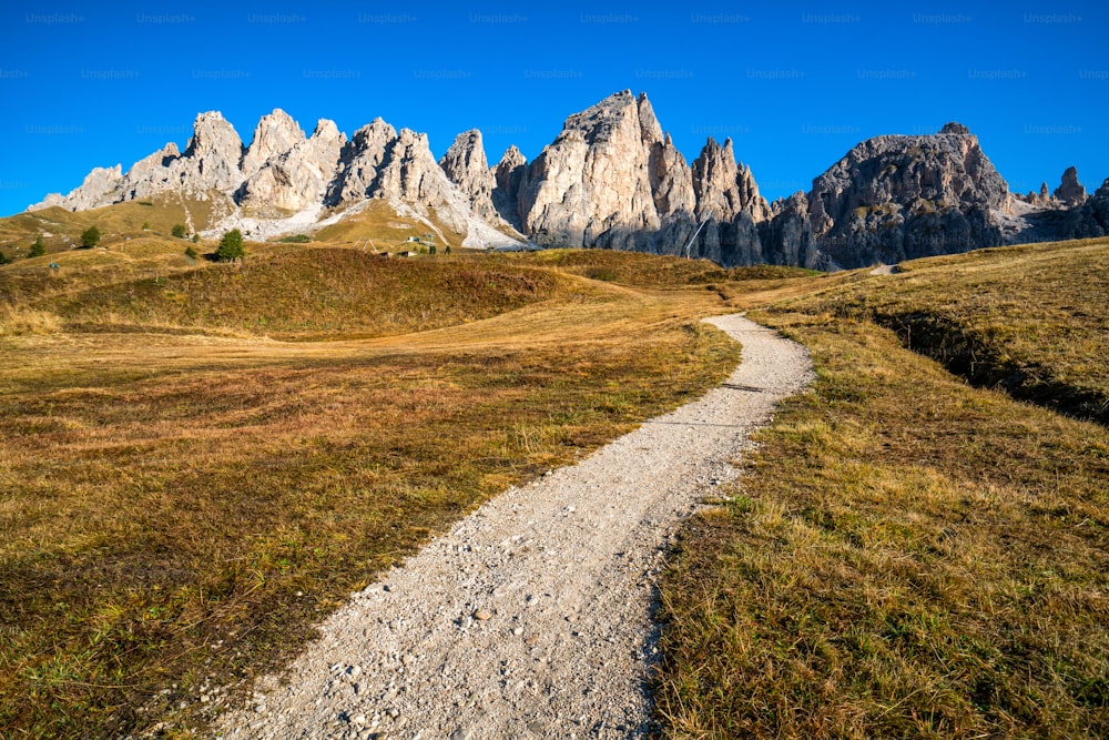 Dirt road and hiking trail track in Dolomites mountain, Italy, in front of Pizes de Cir Ridge mountain ranges in Bolzano, South Tyrol, Northwestern Dolomites, Italy.