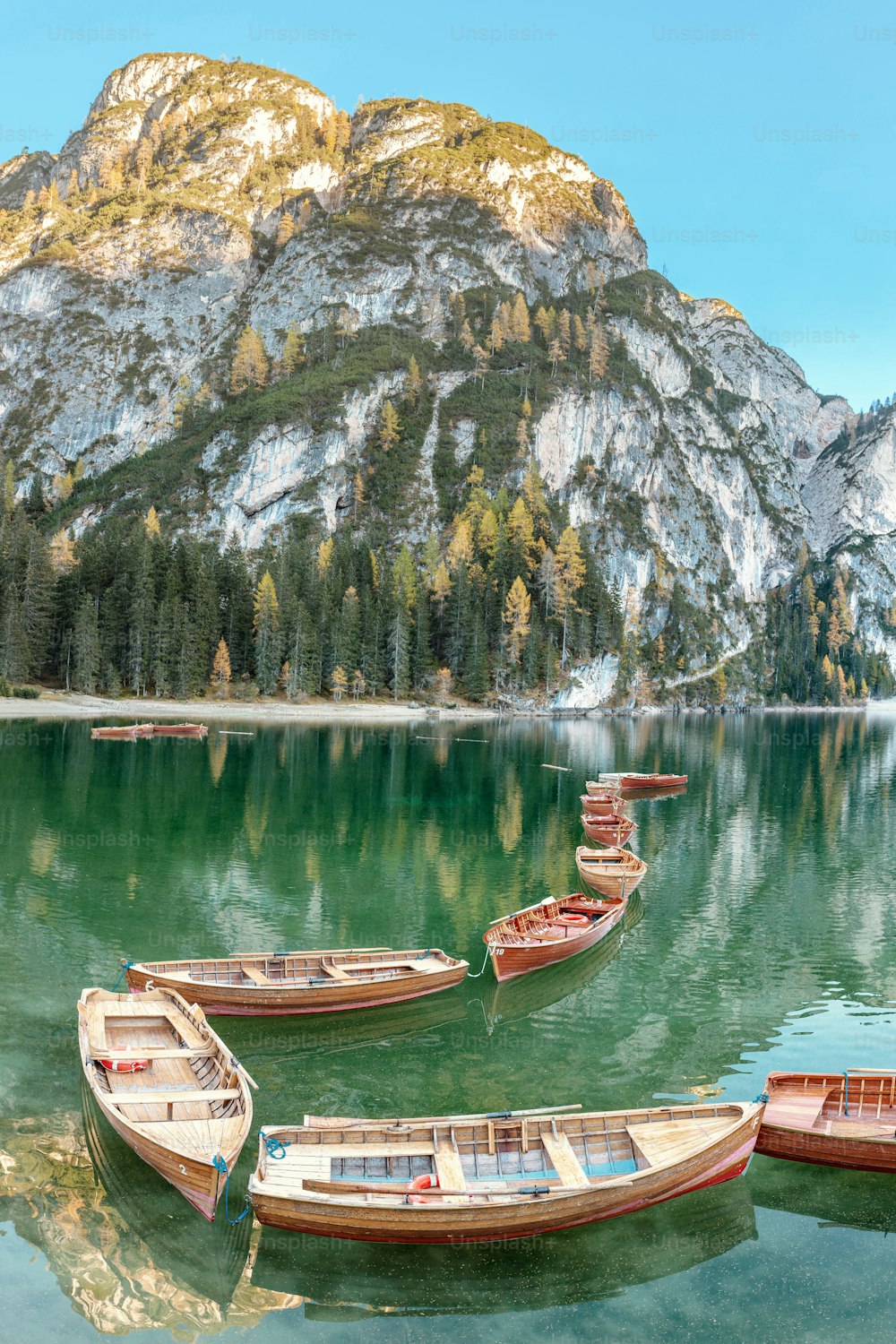 A magical panoramic landscape with calm colors of the famous lake Braies in the Dolomites Alps during autumn season. A popular tourist attraction