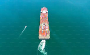 Aerial top view containers ship cargo business commercial trade logistic and transportation of international import export by container freight cargo ship in the open seaport.