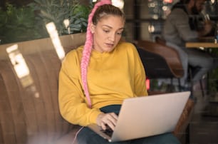 Perfectly relaxed weekend. Young student girl working at cafe.