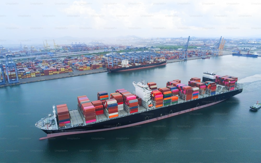 Aerial top view containers ship cargo business commercial trade logistic and transportation of international import export by container freight cargo ship in the open seaport.