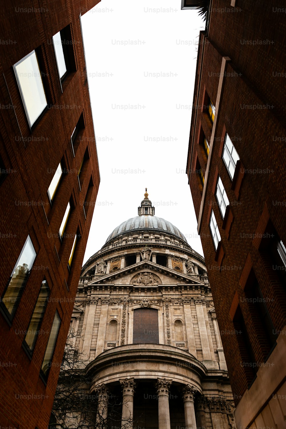 Vista lateral da Catedral de St.Paul, em Londres, vista através de uma rua estreita. Construído após o Grande Incêndio de Londres de 1666, é a obra-prima de Christopher Wren e uma das atrações mais turísticas da cidade.