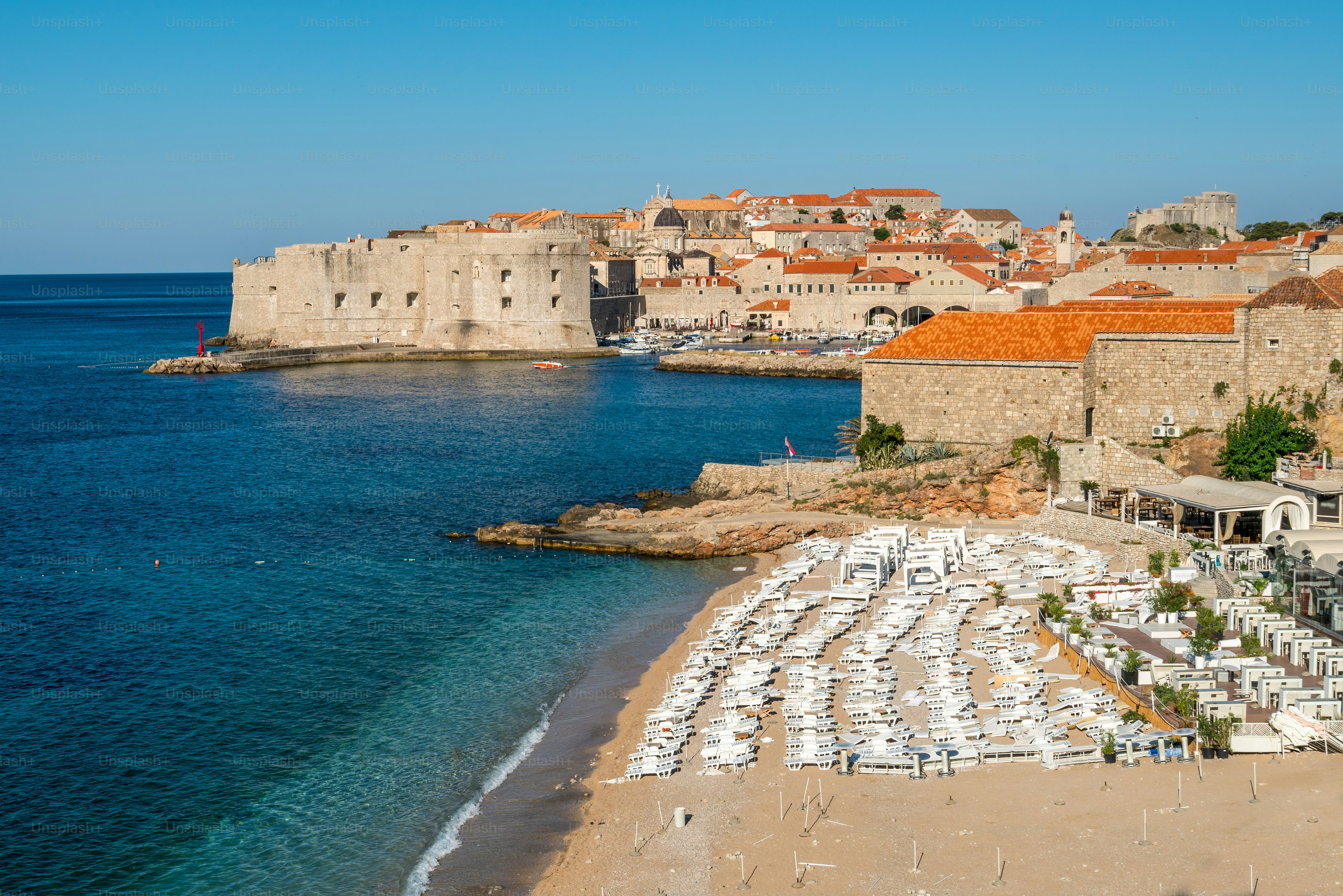 Beach of Dubrovnik Old Town in Dalmatia, Croatia. Banje beach is the most famous Dubrovnik's public beach. Dubrovnik old town was listed as UNESCO World Heritage Sites in 1979.