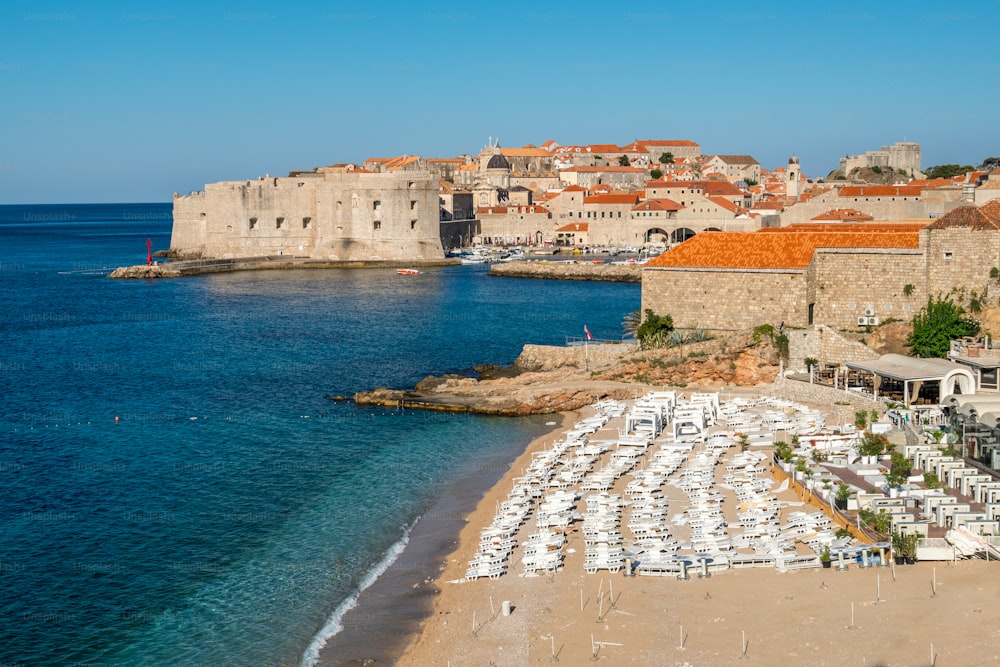 Beach of Dubrovnik Old Town in Dalmatia, Croatia. Banje beach is the most famous Dubrovnik's public beach. Dubrovnik old town was listed as UNESCO World Heritage Sites in 1979.