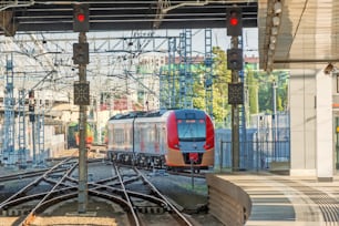 Train passing a railroad crossing. Dutch signs warning not go and red lights flashing