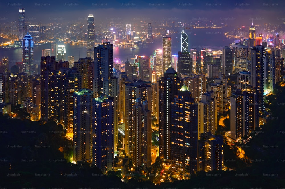 Famous view of Hong Kong - Hong Kong skyscrapers skyline cityscape view from Victoria Peak illuminated in the evening blue hour. Hong Kong, China