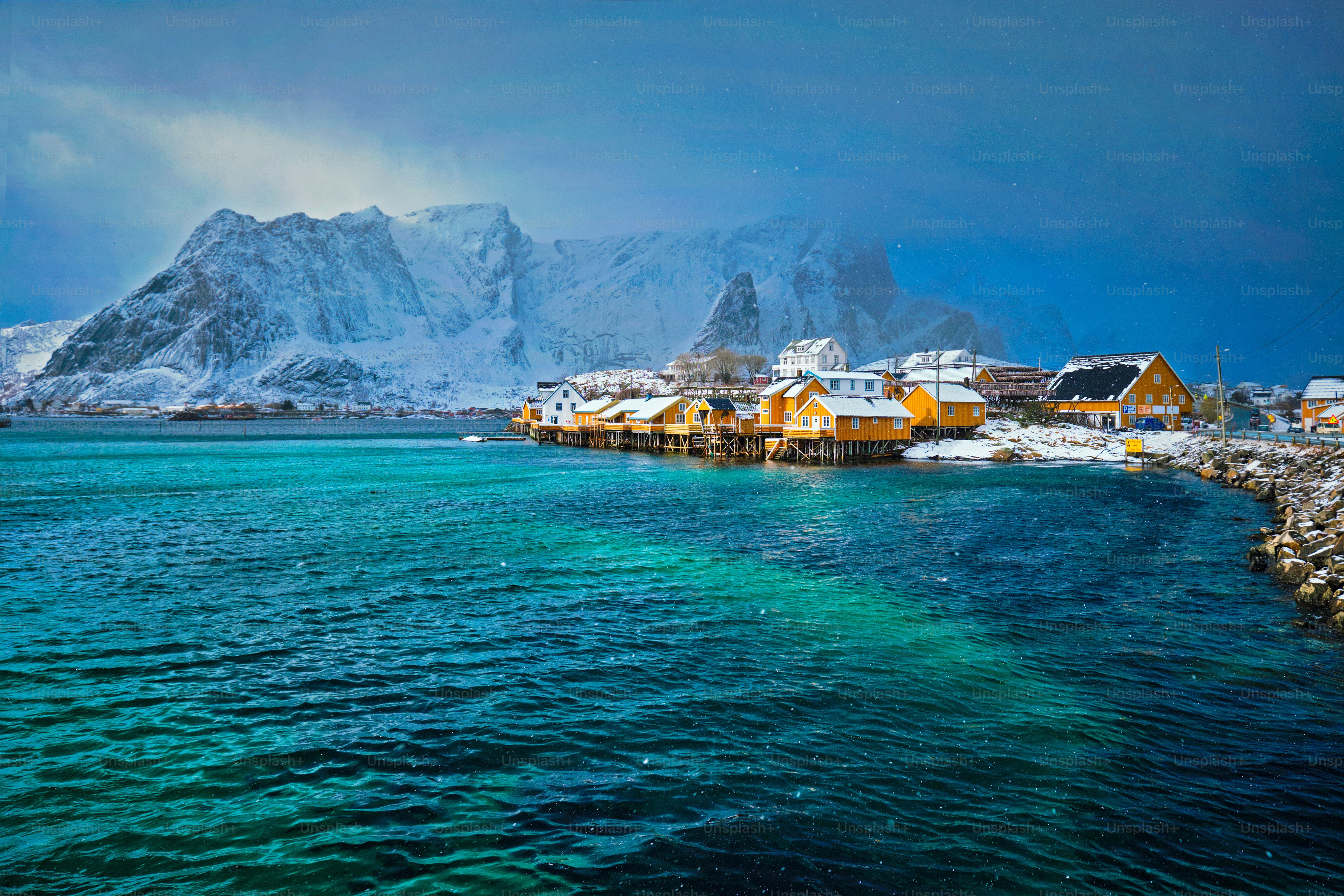 Yellow rorbu houses of Sakrisoy fishing village with snow in winter. Lofoten islands, Norway