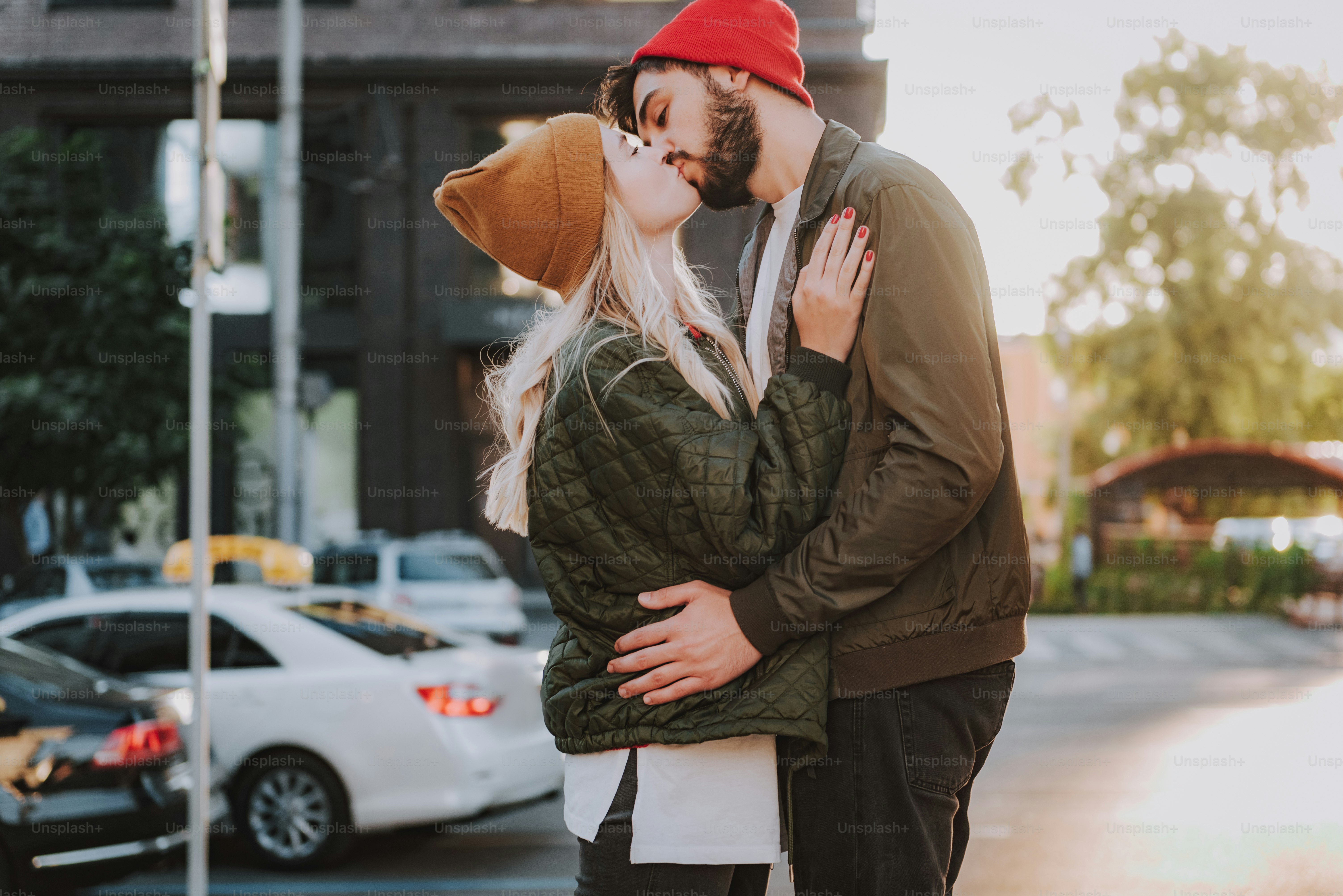 Side view waist up portrait of charming lady in hat sharing romantic intimate moment with her boyfriend