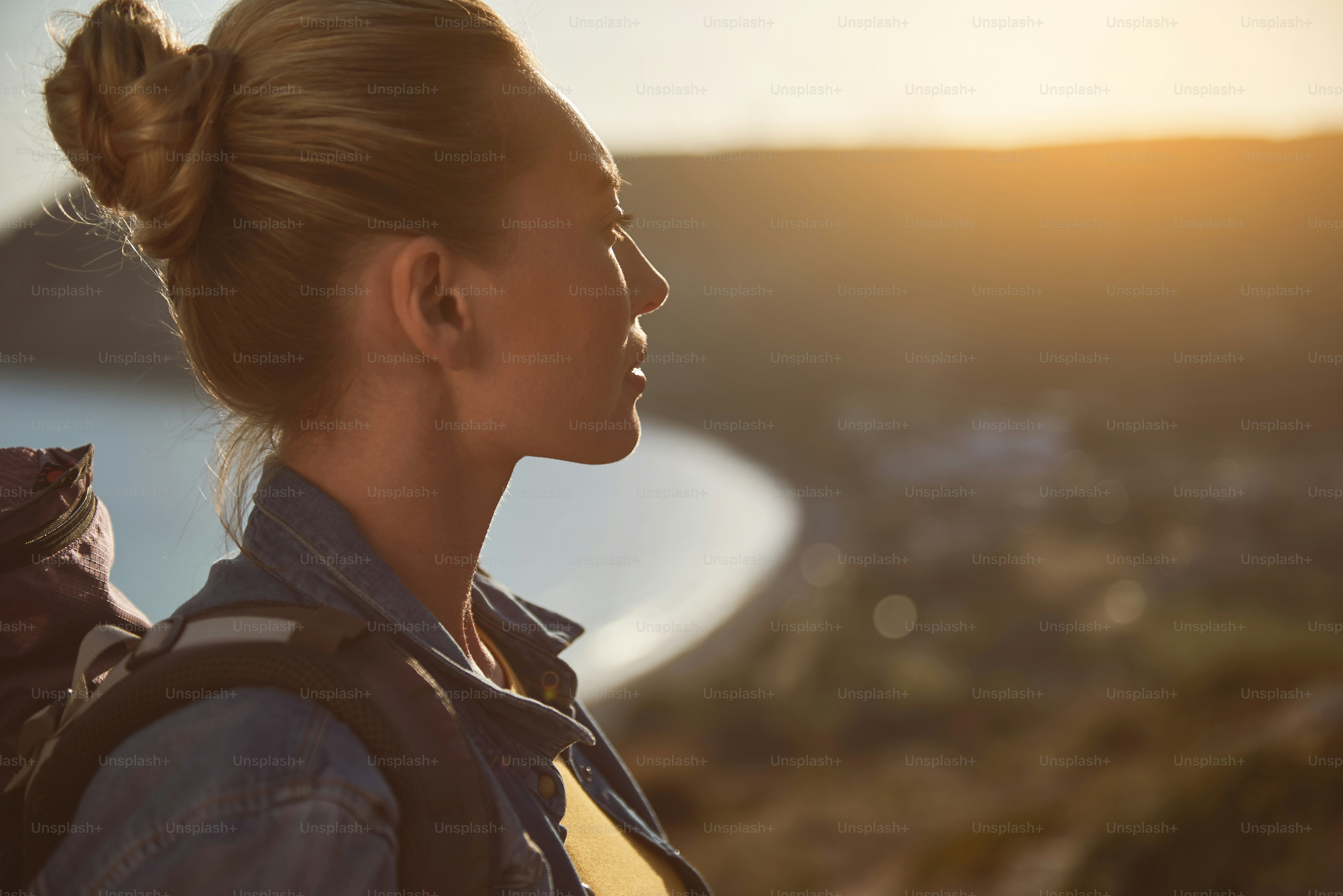 Profile of calm female tourist enjoying landscape. Focus on woman. Copy space in right side