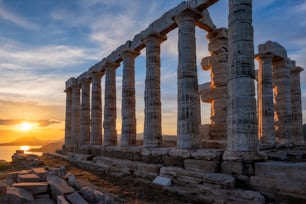 Cape Sounio sunset at Sounion with ruins of the iconic Poseidon temple. One of the Twelve Olympian Gods of ancient Greek religion and mythology. God of the sea, earthquakes. Aegean coast, Greece.